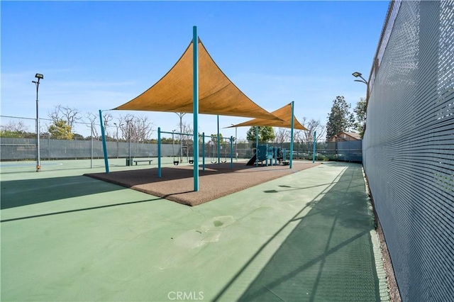 view of community featuring fence and playground community