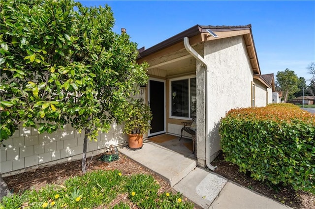 property entrance with stucco siding