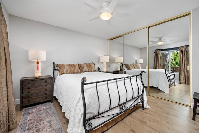 bedroom featuring ceiling fan, a closet, and light wood-type flooring