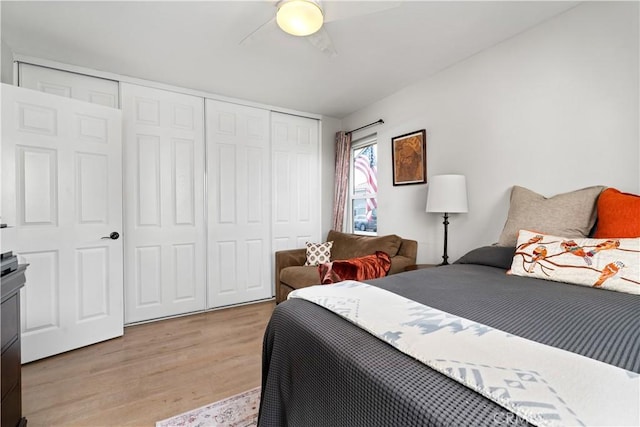 bedroom with light wood finished floors, ceiling fan, and a closet