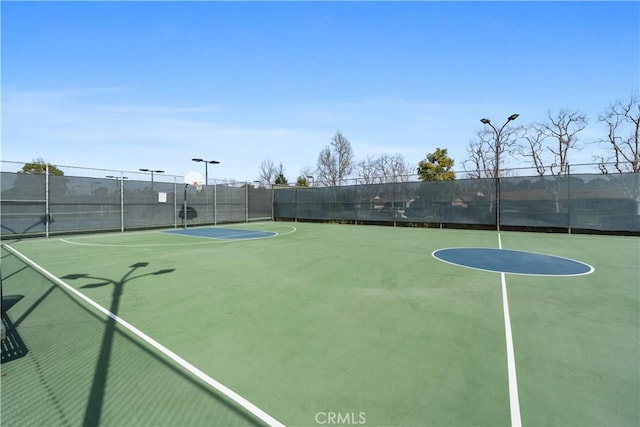 exterior space with community basketball court and fence