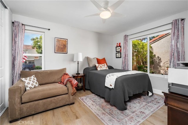 bedroom with a ceiling fan and wood finished floors