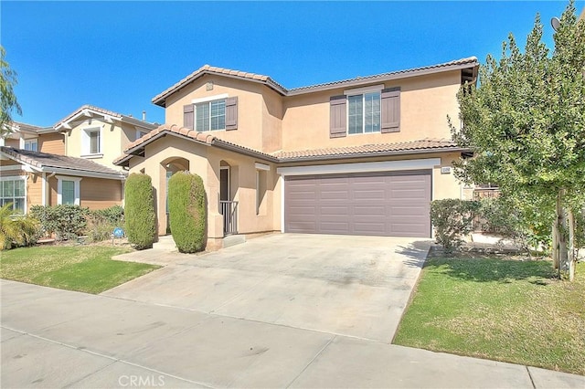 mediterranean / spanish-style home with concrete driveway, a tile roof, an attached garage, a front lawn, and stucco siding