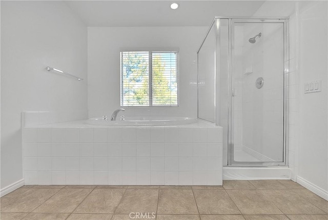 bathroom featuring a stall shower, tile patterned flooring, and a bath