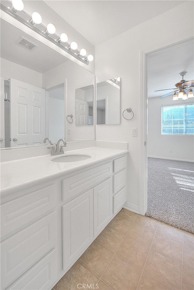 bathroom with baseboards, visible vents, a ceiling fan, tile patterned floors, and vanity