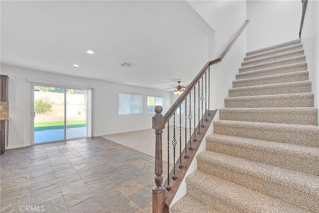 stairs with baseboards, stone tile flooring, visible vents, and recessed lighting