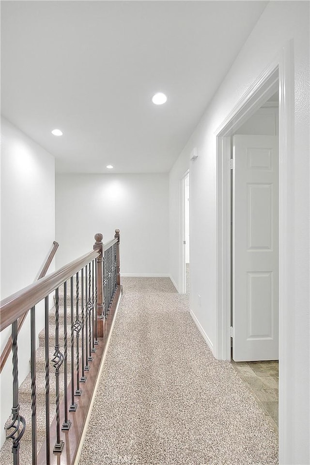 hallway with baseboards, carpet flooring, and recessed lighting