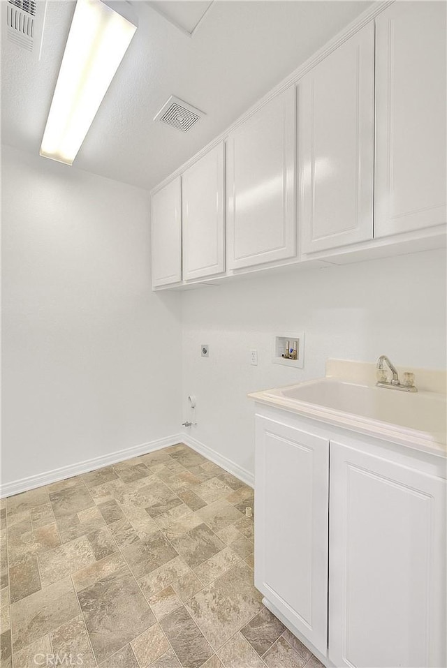 washroom featuring cabinet space, baseboards, visible vents, hookup for a washing machine, and hookup for an electric dryer