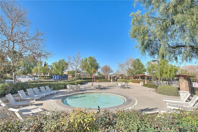 view of swimming pool featuring fence