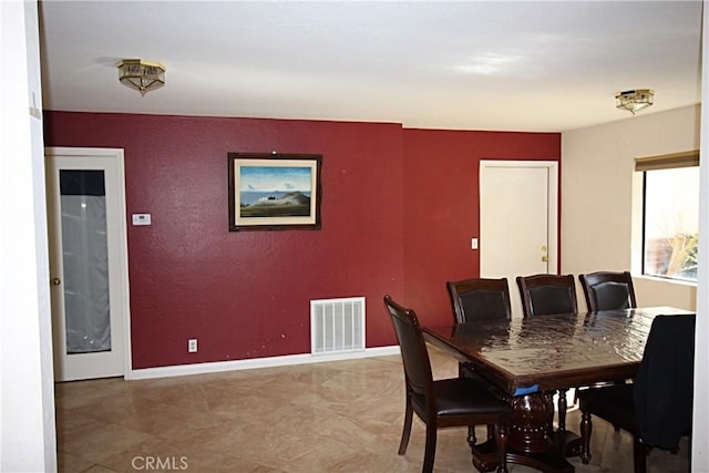 dining room with visible vents and baseboards