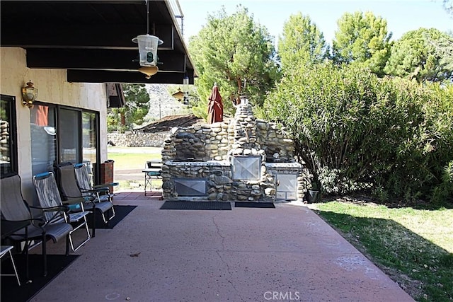 view of patio / terrace with an outdoor stone fireplace