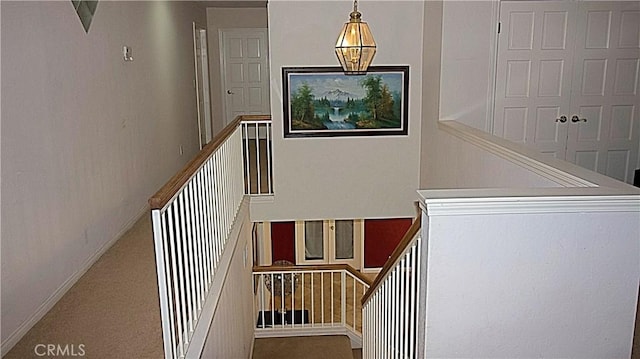 stairs featuring carpet and baseboards