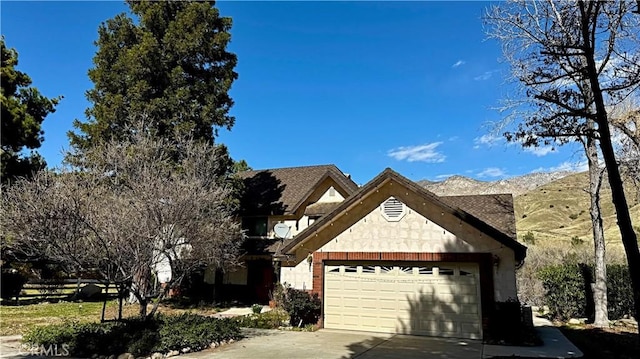 view of front of house featuring concrete driveway and an attached garage