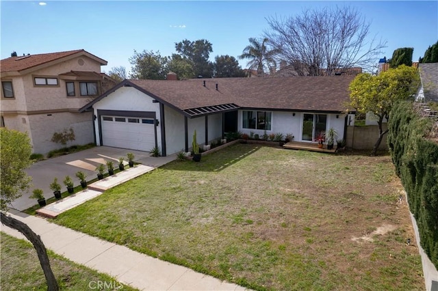 view of front of home with a garage, concrete driveway, fence, a front yard, and stucco siding