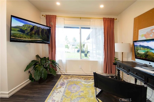 sitting room with baseboards, dark wood finished floors, a wealth of natural light, and recessed lighting