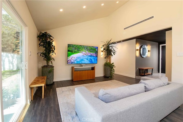 living area with high vaulted ceiling, dark wood finished floors, a wealth of natural light, and recessed lighting