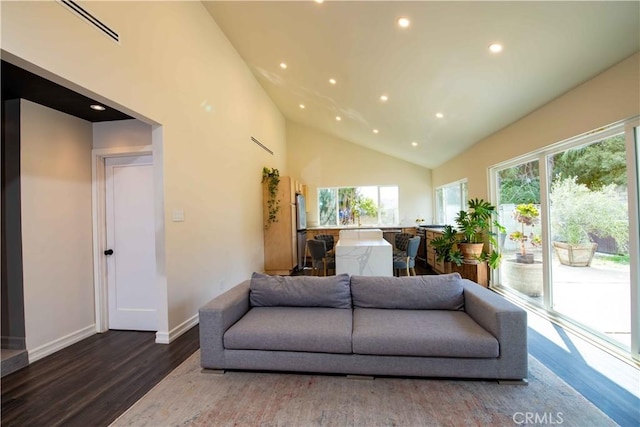 living area with baseboards, visible vents, wood finished floors, high vaulted ceiling, and recessed lighting