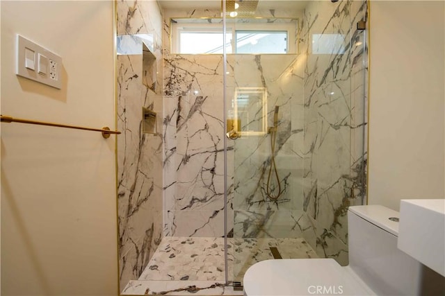 full bathroom featuring toilet and a marble finish shower