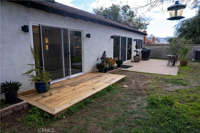 back of house with a patio area, fence, and stucco siding