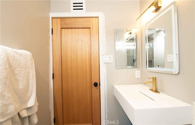 bathroom with a sink and visible vents