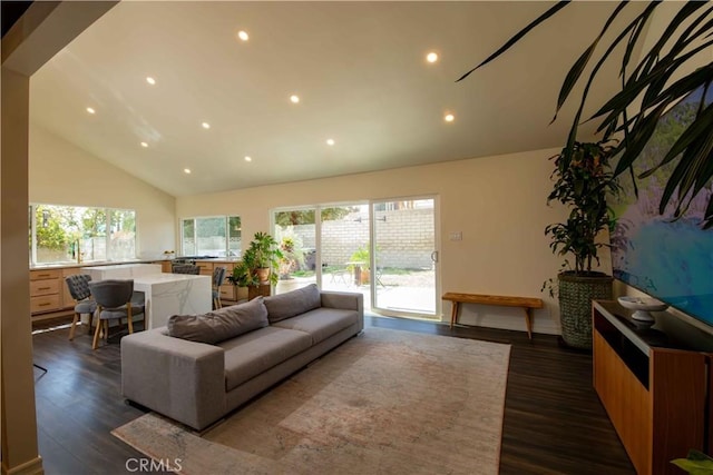 living room with plenty of natural light, high vaulted ceiling, dark wood finished floors, and recessed lighting