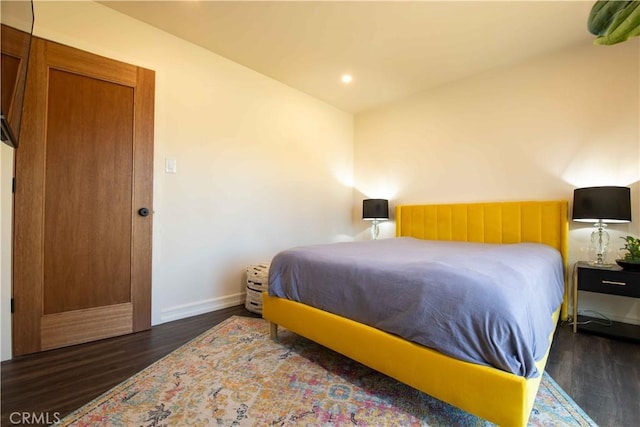 bedroom with recessed lighting, lofted ceiling, baseboards, and wood finished floors