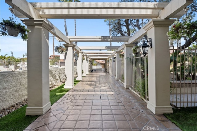 view of patio / terrace featuring fence, a gate, and a pergola