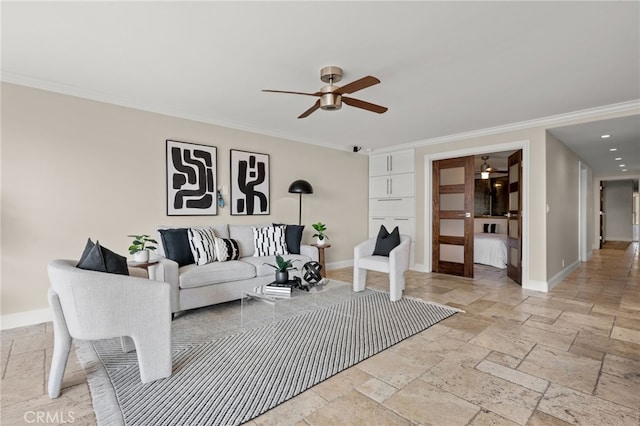 living room with baseboards, ornamental molding, and stone tile floors