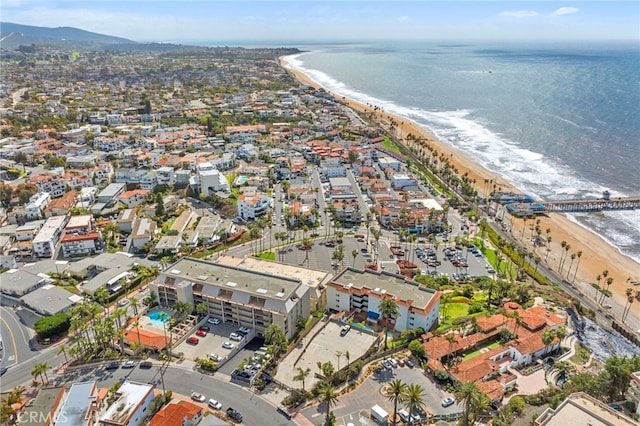 drone / aerial view with a water view and a beach view