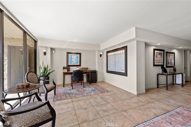 interior space with light tile patterned floors, mail area, and baseboards