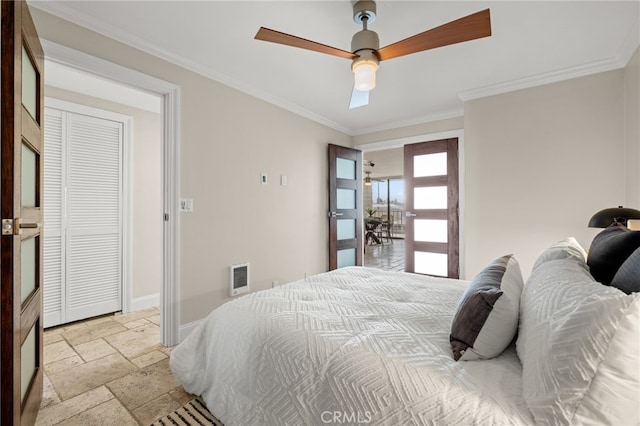 bedroom with a ceiling fan, stone tile floors, ornamental molding, and baseboards