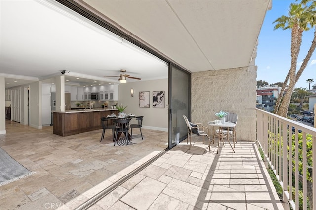 balcony with ceiling fan and outdoor dining area