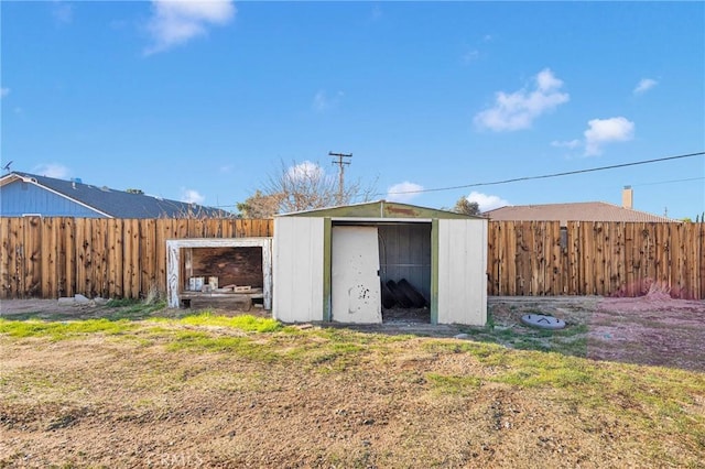 view of shed with a fenced backyard