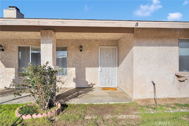 property entrance with stucco siding