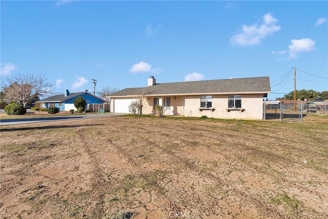 single story home with a chimney, a front yard, a gate, fence, and a garage