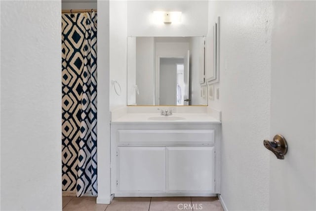 full bath featuring a shower with shower curtain, tile patterned flooring, and vanity