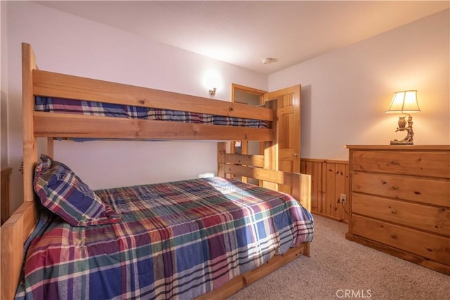 carpeted bedroom with wainscoting