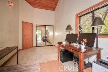 office area with high vaulted ceiling, wood ceiling, a healthy amount of sunlight, and baseboards