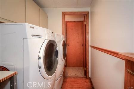 laundry room with light wood-style floors and independent washer and dryer