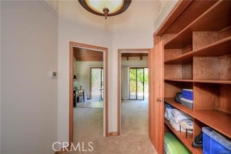 interior space featuring a towering ceiling, carpet, and baseboards