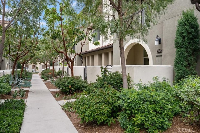 view of property exterior featuring fence and stucco siding