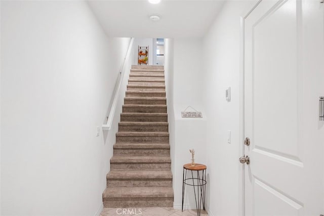 staircase featuring baseboards