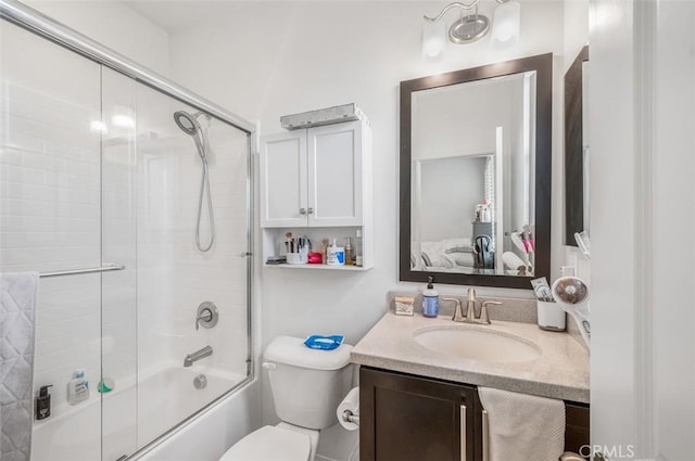 bathroom with shower / bath combination with glass door, vanity, and toilet