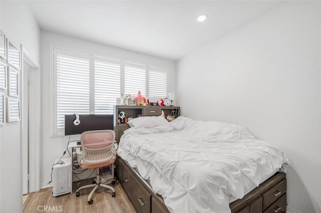 bedroom with recessed lighting and light wood-style floors