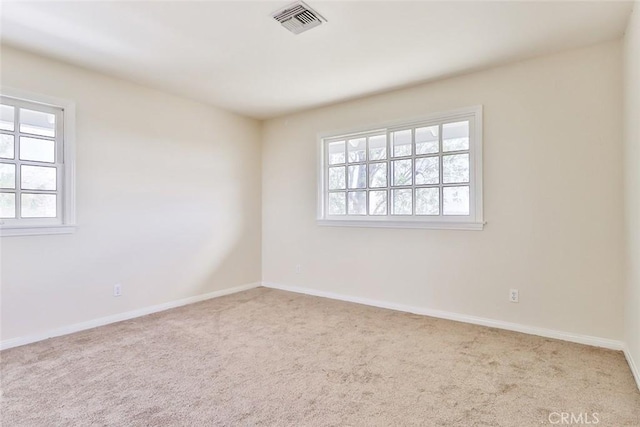 unfurnished room featuring visible vents, baseboards, and carpet floors