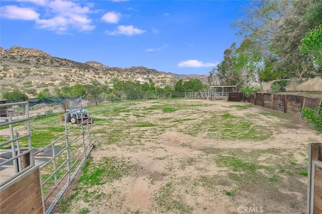 view of yard with an exterior structure, a mountain view, and an outdoor structure