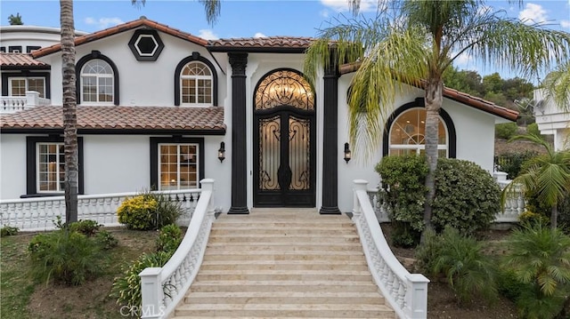 view of front of house with a tile roof and stucco siding