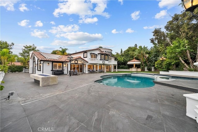 outdoor pool featuring a patio and an outdoor fire pit