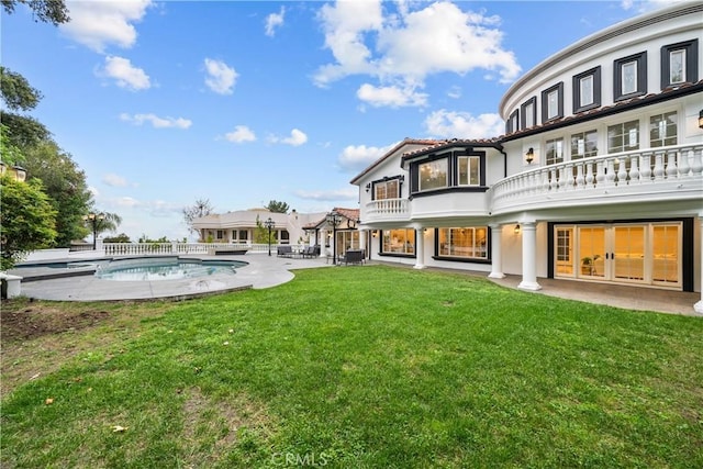 rear view of property with a patio, a balcony, central air condition unit, a lawn, and an outdoor pool