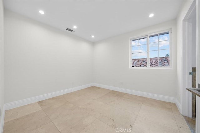 unfurnished room with recessed lighting, visible vents, and baseboards